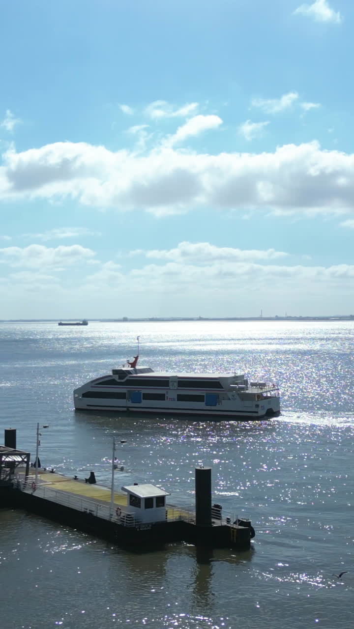 Aerial portrait following a ferry arriving at the Terminal, sunny day in Lisbon