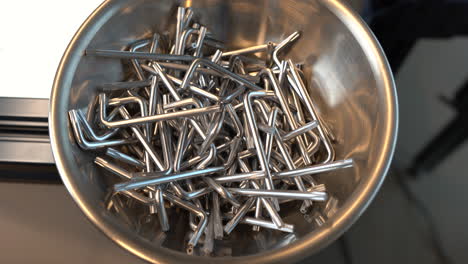 close-up view of multiple bowls filled with allen wrenches