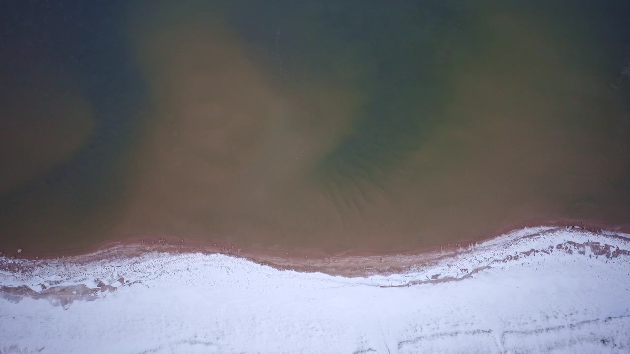 Drone shot of lake superior and coast in winter in the upper peninsula of Michigan