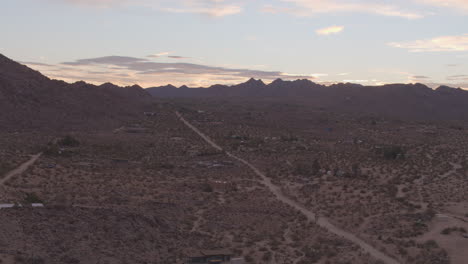 aerial boom up over beautiful desert landscape in joshua tree, california at sunrise