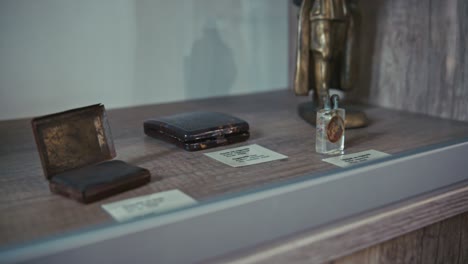 antique cigarette cases and lighter on display in a museum
