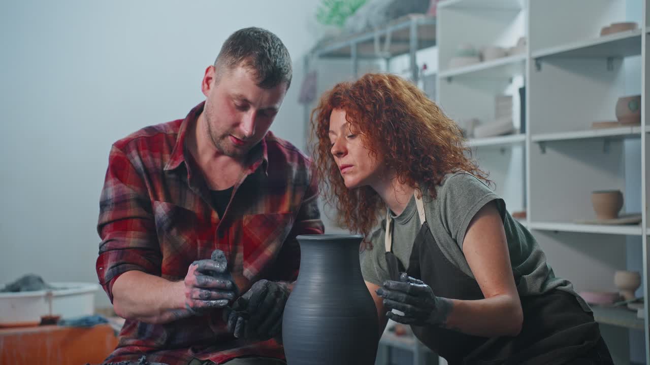 Couple working on a pottery piece
