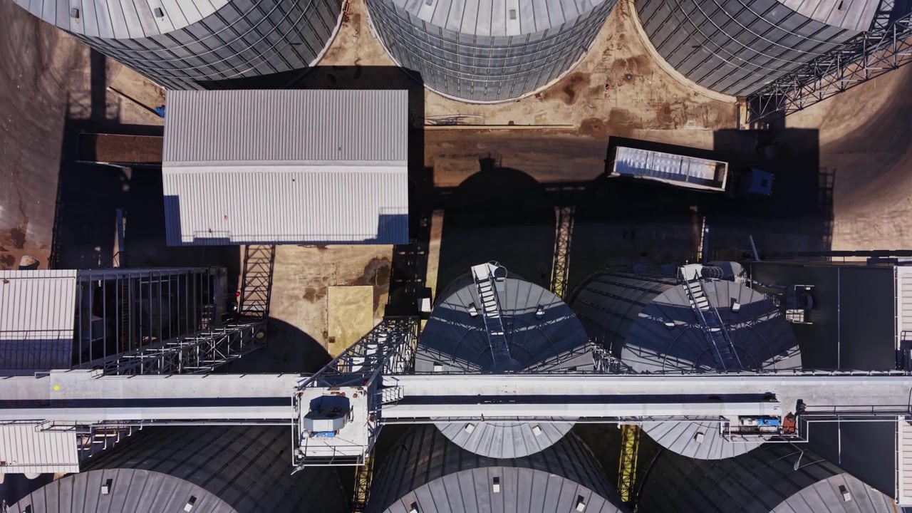 Grain storage silos viewed from above during daylight