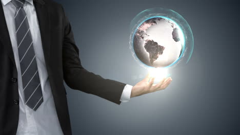 businessman holding digital generated globe