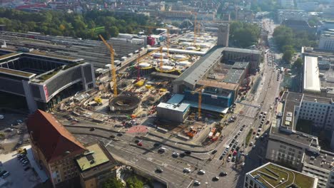 aerial of huge railroads, intersection and construction site of main train station stuttgart s21 with cranes and construction worker in stuttgart, germany