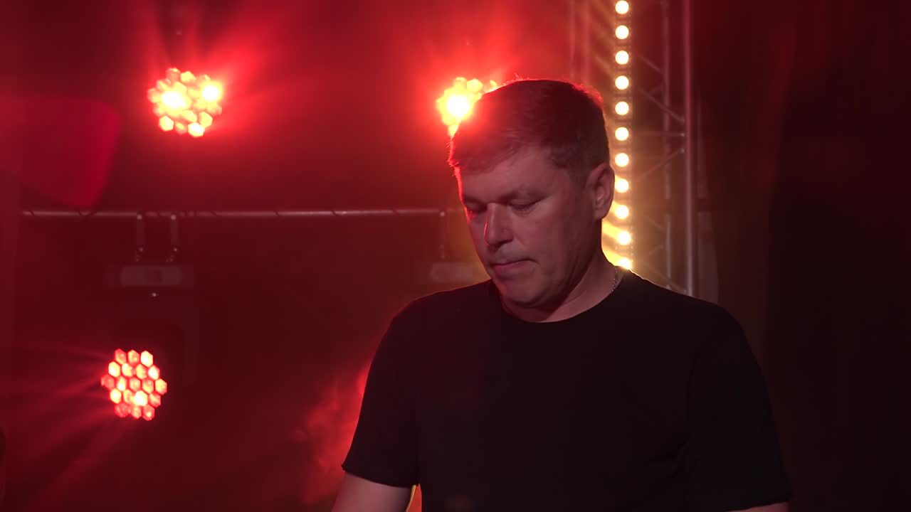 los músicos tocan el sintetizador de piano, el teclado y la batería en un estudio oscuro con humo y iluminación de neón. efectos dinámicos de iluminación de neon. interpretación de la banda vocal y musical.