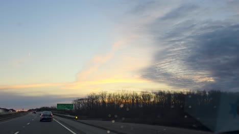 highway at sunset with clouded sky