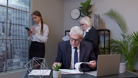 businessman developing new project while analysis financial graph data sits at office desk workplace