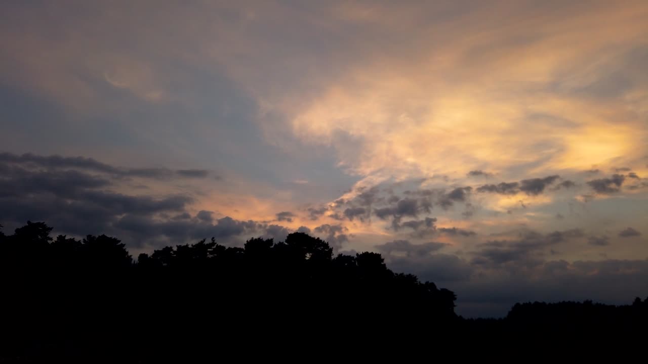 하늘과 주황색 청록색 톤에 구름이 거의 없는 도시에서 일몰의 저속