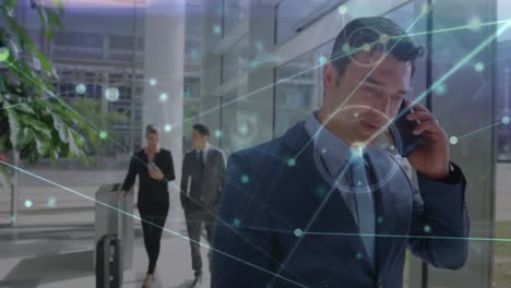 animation of networks of connections over mixed race businessman talking on smartphone in office