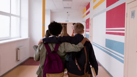two friends walking together in a school hallway