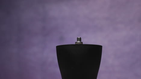 coffee preparation sprinkling grains into a hand grinder from a paper bag detailed view from the bottom view of the grinder captured in slow motion at 120 fps