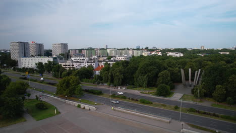 Aerial-wide-shot-showing-cars-on-intersection-and-suburb-residential-area-of-Warsaw-in-Background