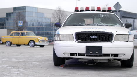 police car in front of a building in winter