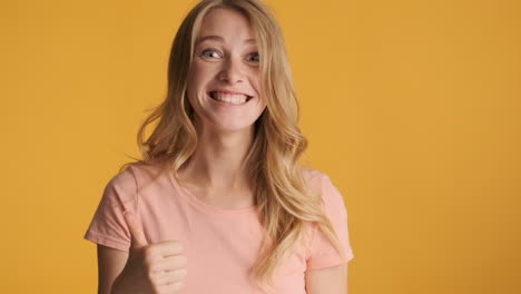 Caucasian-woman-celebrating-and-keeping-thumb-up-on-camera.