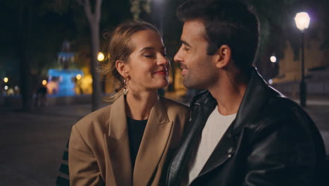 romantic lovers sitting park together closeup. smiling love couple looking eyes