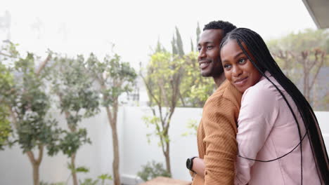 smiling african american couple embracing outdoors, enjoying quality time at home, copy space