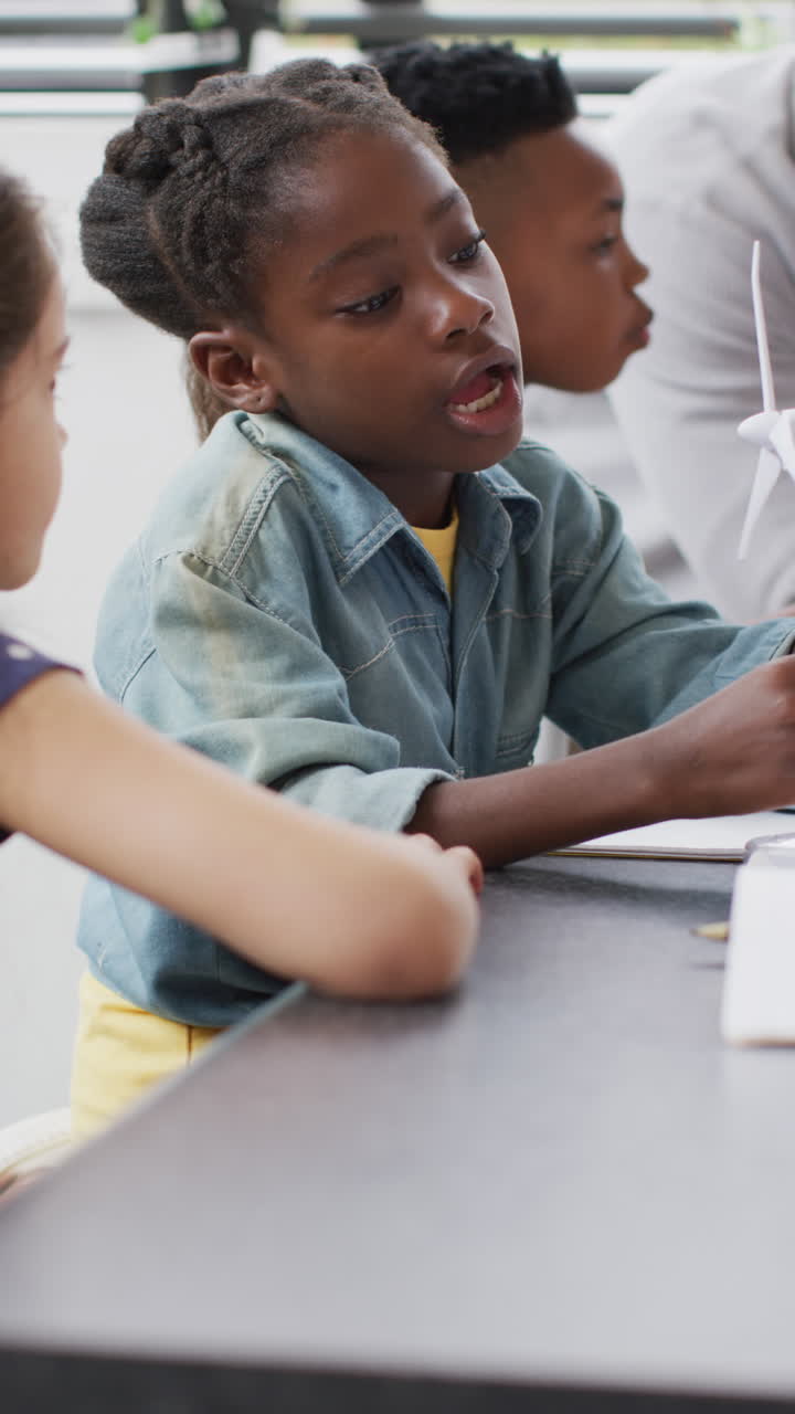 Vertical video of happy diverse schoolchildren in school lab