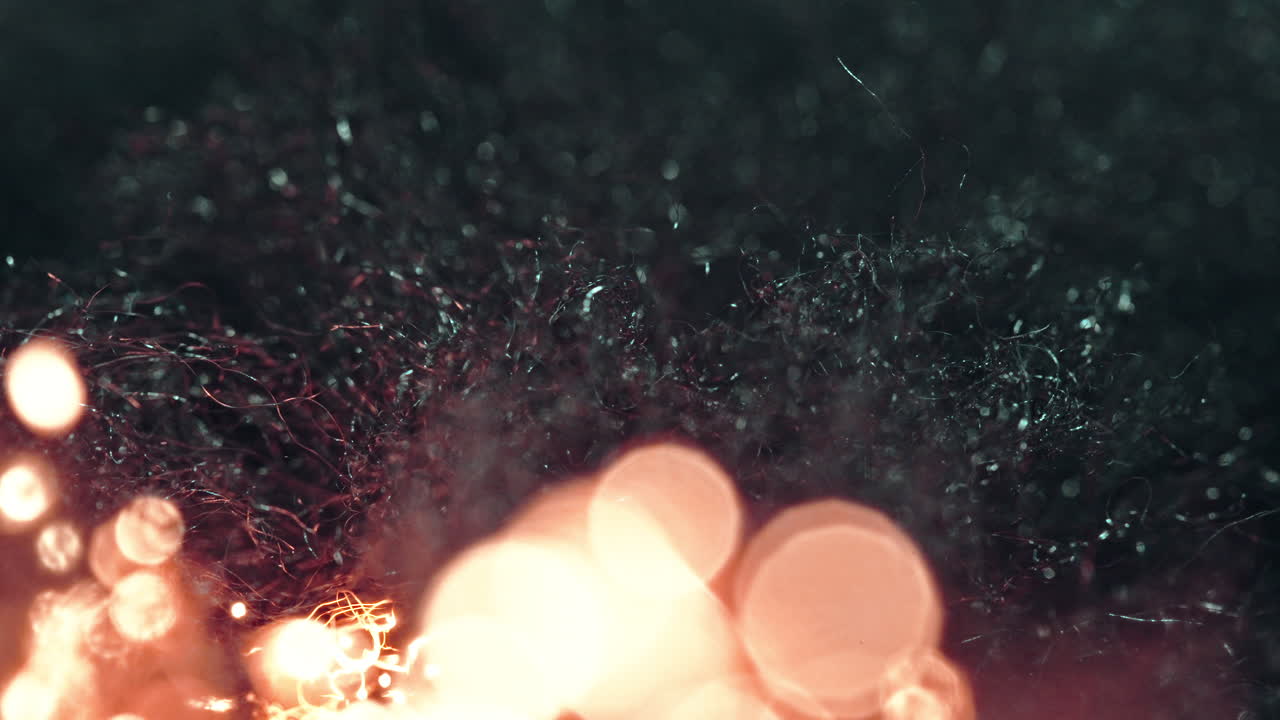 glowing steel wool fire sparks illuminating the darkness