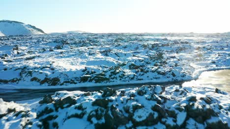 4K-drone,-aerial,-cinematic-like-a-birdseye-view-of-Icelandic-snow-blanketed-landscape-and-mountain