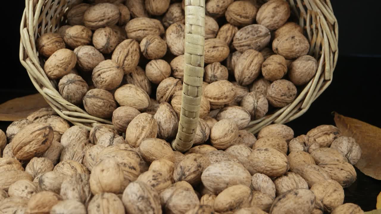 A pile of walnuts lies in the wicker basket