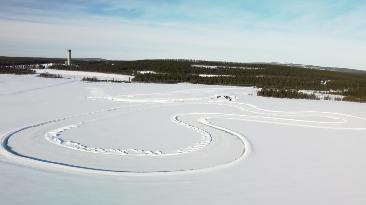 Whole Race track on a Frozen Lake in Finland during golden hour – Aerial Winter Landscape high altitude orbit shot
