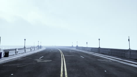 Asphalt-highway-and-mountain-in-deep-fog