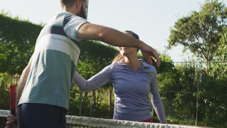 video of happy caucasian couple shaking hands on the court