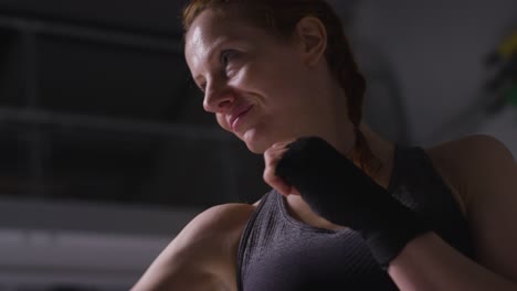 close up shot of mature woman wearing gym fitness clothing exercising sparring