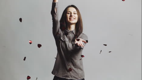 woman throwing red hearts