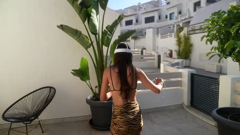 woman wearing vr headset dancing on a patio