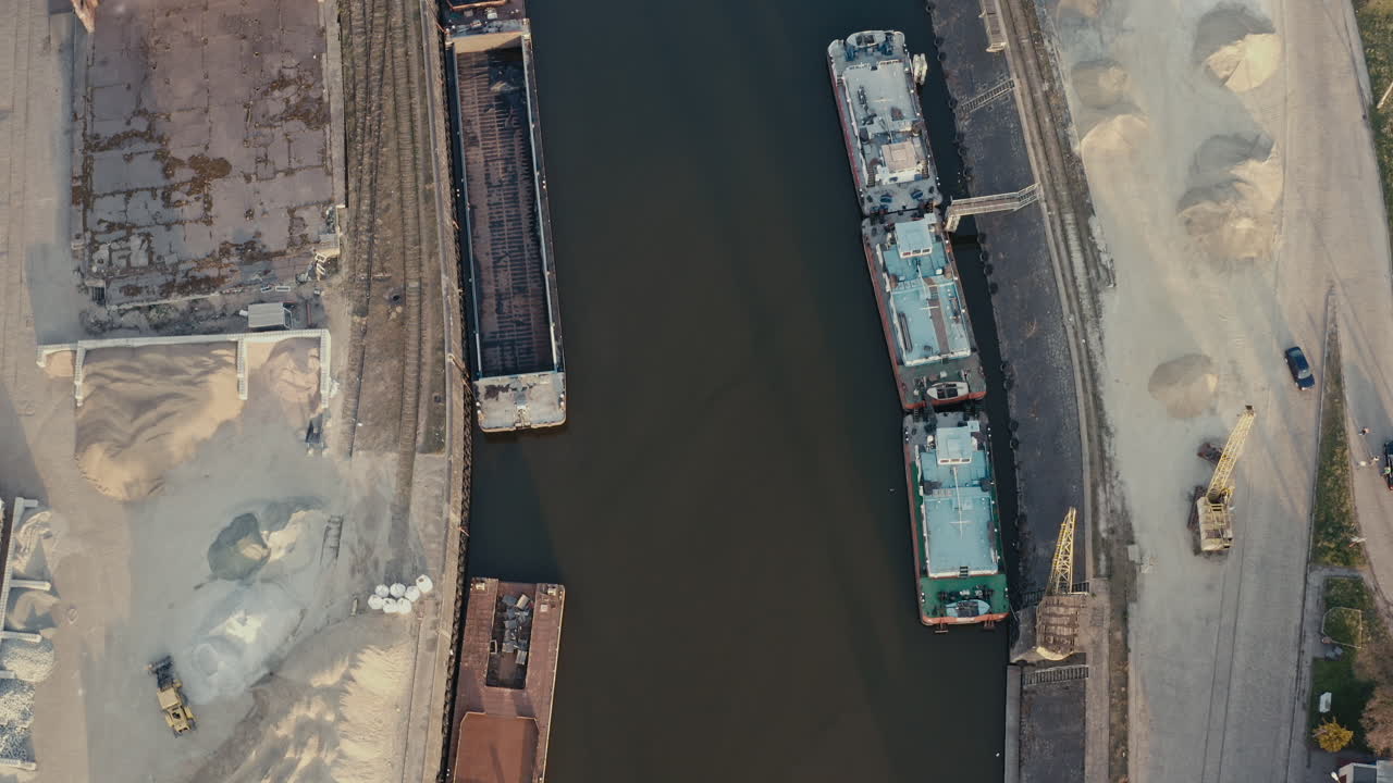 Aerial view of a canal with barges and industrial facilities