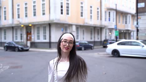 Beautiful-woman-turns,-hair-flips,-smiles-in-Soho,-London,-medium-shot-slow-motion