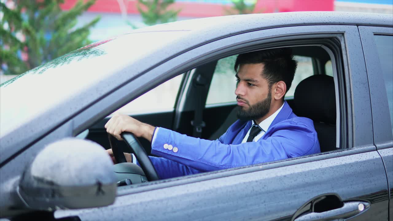 Businessman Driving a Car in the Rain