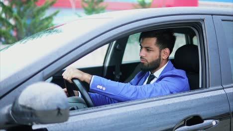 businessman driving a car in the rain