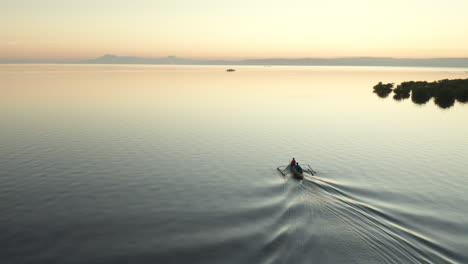 Aerial-closing-in-on-a-wooden-fishing-boat-with-sunset