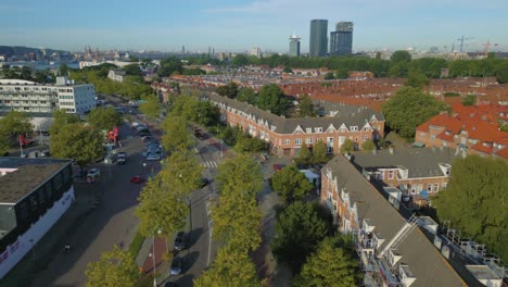 Backward-aerial-of-Vogelbuurt-with-houses,-apartments-and-flats-in-Amsterdam-Noord