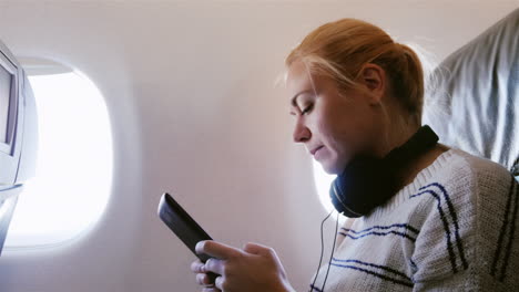 young attractive woman is flying in an airplane 4