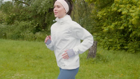 close up of woman wearing headband exercising keeping fit running in rain