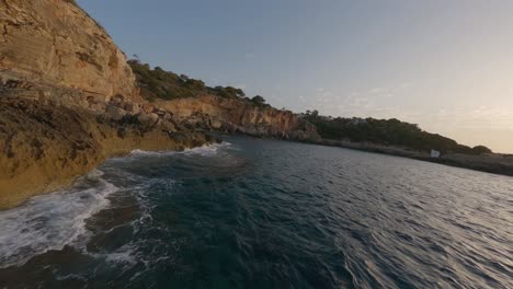 Low-water-morning-FPV-aerial-along-golden-rock