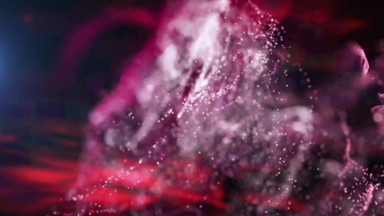 Animation of red and pink particle clouds moving on black background