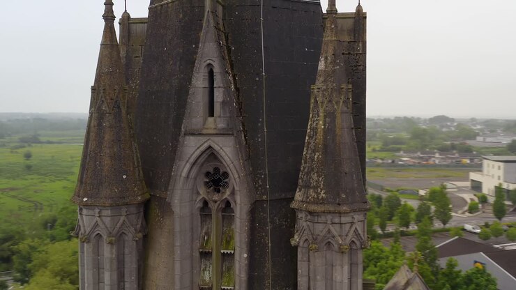 Saint Michael's Church in Ballinasloe Galway push in and orbit around lichen covered gothic towers