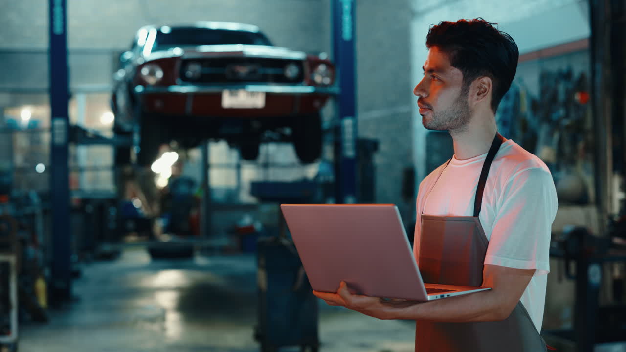 Mechanic Using Laptop in Garage