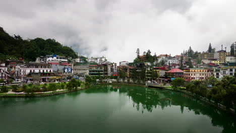 aerial view over calm sa pa lake with reflections and low clouds, north vietnam