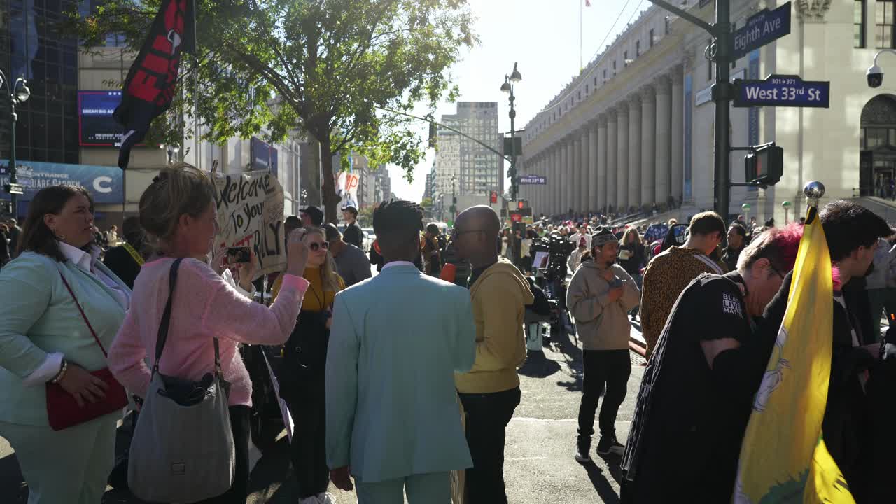 The sun shines brightly on the crowd gathered near Madison Square Garden, where Trump supporters enthusiastically chant and wave signs