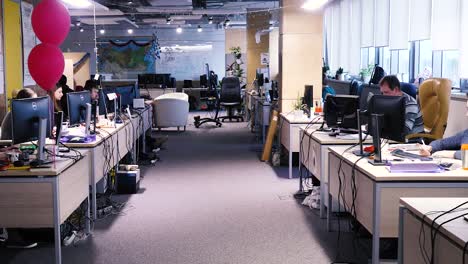 busy open office space with employees working at desks