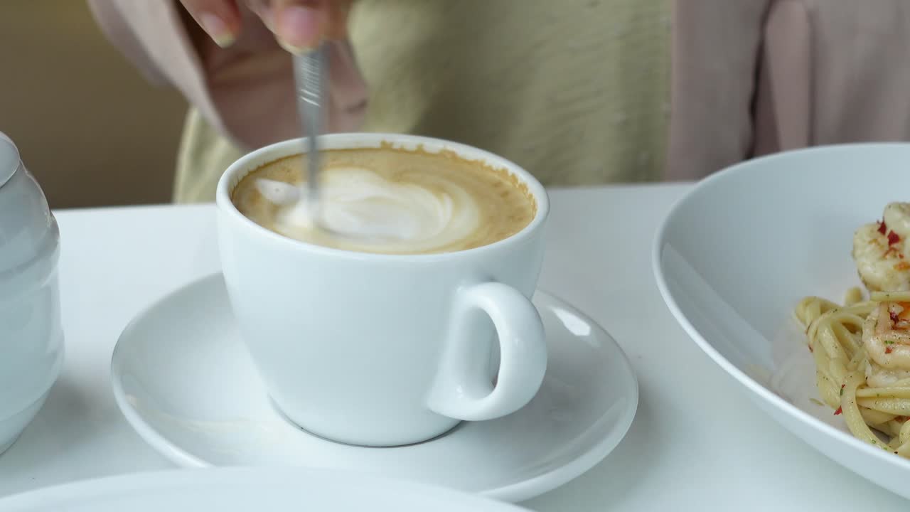 Enjoying Coffee and Pasta at a Cafe