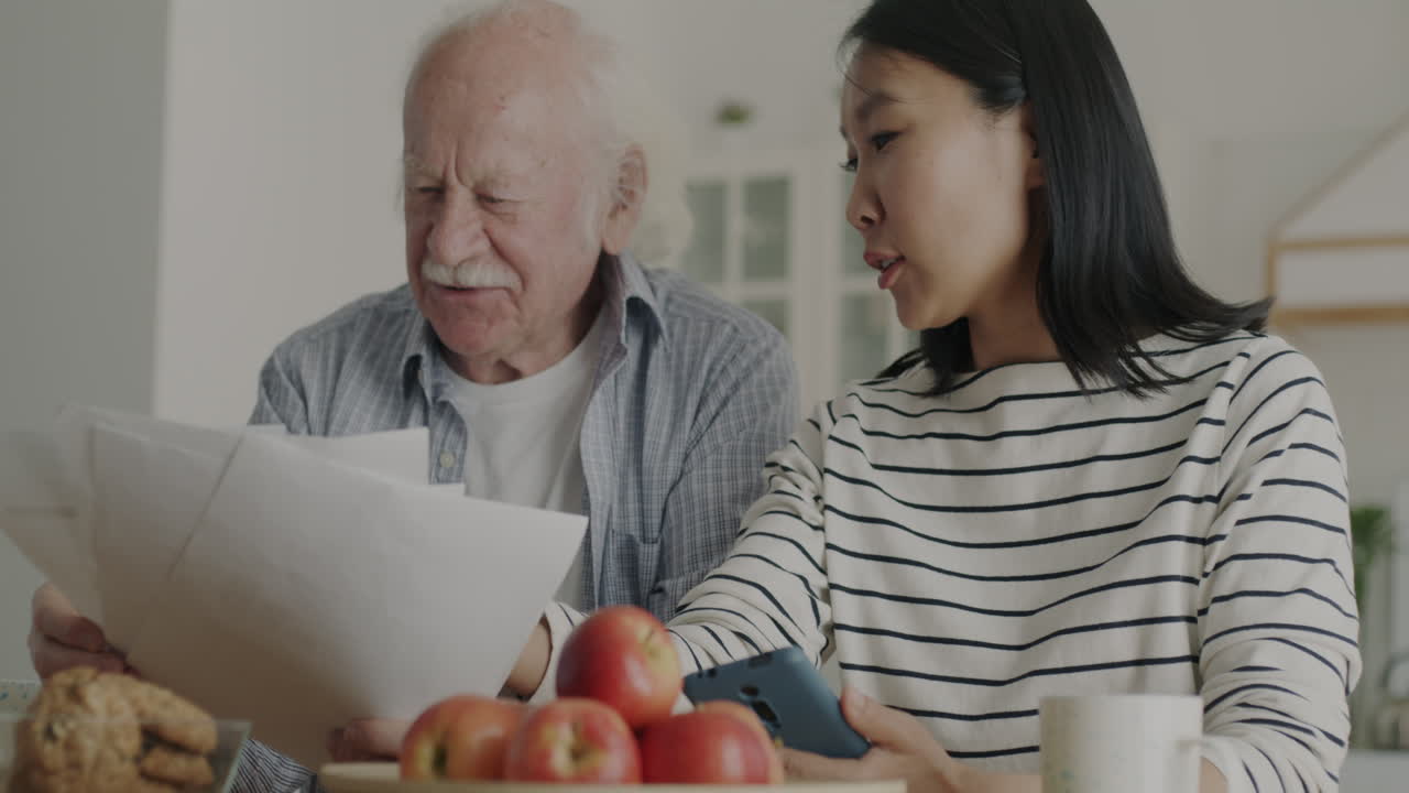 Grandchild Assisting Elderly Parent with Documents