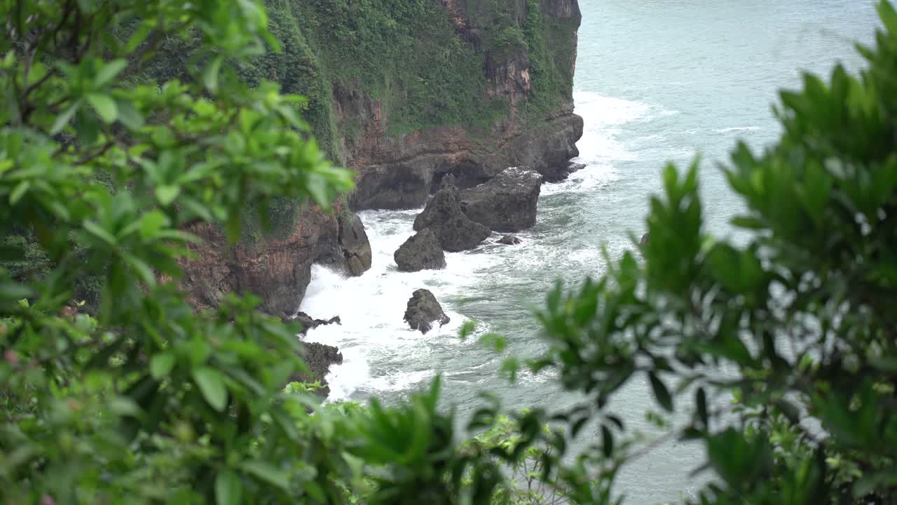 The waves crashing against the rocks on the coast of the South Sea of Java