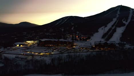 People-coming-out-of-lodge-at-a-ski-resort--drone-video